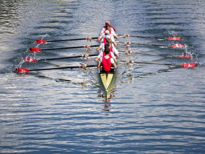 Rowers in eight-oar rowing boats on the tranquil lake